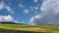 Three riders on horseback travel through alpine meadows in the mountains. Royalty Free Stock Photo