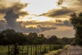 Three riders in a dirt road with a very expressive sky in CÃÂ³rdoba, Argentina Royalty Free Stock Photo