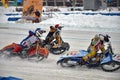 Three riders ice speedway compete on corner entry