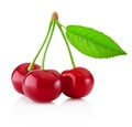 Three ripe cherries with leaf isolated on white background