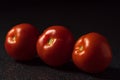 Three ripe red tomatos on a dark background Royalty Free Stock Photo