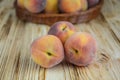 Three ripe peaches on a wooden background Royalty Free Stock Photo