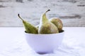 Three ripe pears in violet porcalain bowl Royalty Free Stock Photo