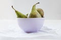 Three ripe pears in violet porcalain bowl Royalty Free Stock Photo