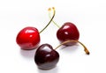 Three ripe red cherries close up on a white background. A group of delicious and beautiful cherries Royalty Free Stock Photo