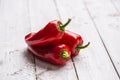 Three ripe red peppers paprika on wooden board Royalty Free Stock Photo