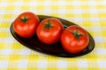 Three ripe red tomatoes in glass dish Royalty Free Stock Photo