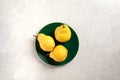 Three ripe yellow pears on green plate Royalty Free Stock Photo