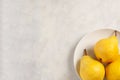 Three ripe yellow pears on white round plate Royalty Free Stock Photo
