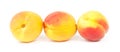 Three ripe yellow-red peaches on a white background in a row Royalty Free Stock Photo