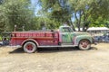 Old vintage dirty fire engine vintage car at an outdoor loam parking lot in three rivers