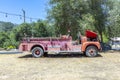 Old vintage dirty fire engine vintage car at an outdoor loam parking lot in three rivers