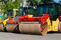 Three road rollers standing on the street