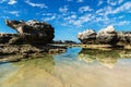 Three rock formations with reflections in the sea at Peterborough beach, Victoria, Australia Royalty Free Stock Photo