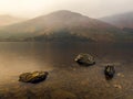 Three rocks in Loch Lochy during rain storm Royalty Free Stock Photo