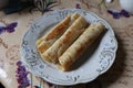 three rolled pancakes on a plate Royalty Free Stock Photo