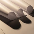 Three rolled sheets of paper are arranged in parallel, casting soft shadows on a flat surface. The Royalty Free Stock Photo