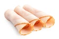 Three rolled up slices of chicken ham isolated on white Royalty Free Stock Photo