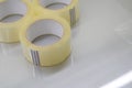 Three rollers of transparent tape. Stationery and packaging consumables. Selective focus.