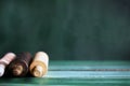 Three Rolling Pins on a Green Rustic Table