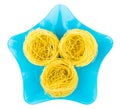 Three rolls of pasta capellini on blue plate Royalty Free Stock Photo