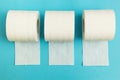 Three rolls of toilet paper on a blue background Royalty Free Stock Photo