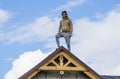 three Roofer man roof carpenter working Country house renovation. looking at camera blue sky beautiful clouds, unfinished wall Royalty Free Stock Photo