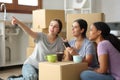 Three roommates planning decoration moving home Royalty Free Stock Photo