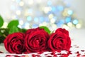 Three roses between small hearts on lights background Royalty Free Stock Photo