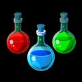 Three round bottom flasks with glowing red blue green liquids Royalty Free Stock Photo