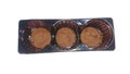 Three round chocolate chip cookies in a rectangular black plastic container, isolated on a white background Royalty Free Stock Photo
