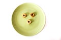 Three round crackers on green plate. Royalty Free Stock Photo
