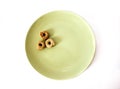 Three round crackers on green plate. Royalty Free Stock Photo