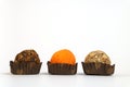 Three round truffle candies in a row. White background with place for text. Calorie food.