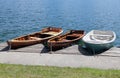 Three rowboats moored on the shore of Lake