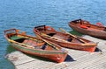 Three rowboats moored on the shore of Lake