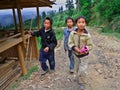 Three rural adolescents aged 12 years and stroll around the neighborhood of the village, Basha Miao Village, Congjiang County, So