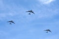 Three Russian military turboprop strategic bombers-missile Tu-95 Bear in flight against the blue sky