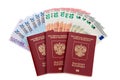 Three russian passports with fan of euro banknotes Royalty Free Stock Photo