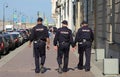 Three Russian police officers walk down the street