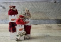 Three rustic snowmen standing on wood surface with a wood background