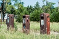 Three Rusty Gas pumps