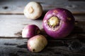 Three rutabaga lying on rustic wood background. Royalty Free Stock Photo
