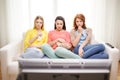 Three sad teenage girl watching tv at home Royalty Free Stock Photo