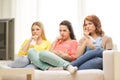 Three sad teenage girl watching tv at home Royalty Free Stock Photo