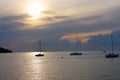 Three sailboats on open sea in a summer at sunset time Royalty Free Stock Photo