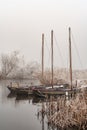 Three sailing boats in a misty cold landscape Royalty Free Stock Photo