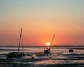 Three sailing boats at low tide during sunset Royalty Free Stock Photo