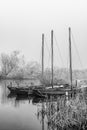 Three sailing boats in a misty cold landscape BW Royalty Free Stock Photo