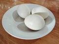 three salted duck eggs available on the table in a small plate Royalty Free Stock Photo